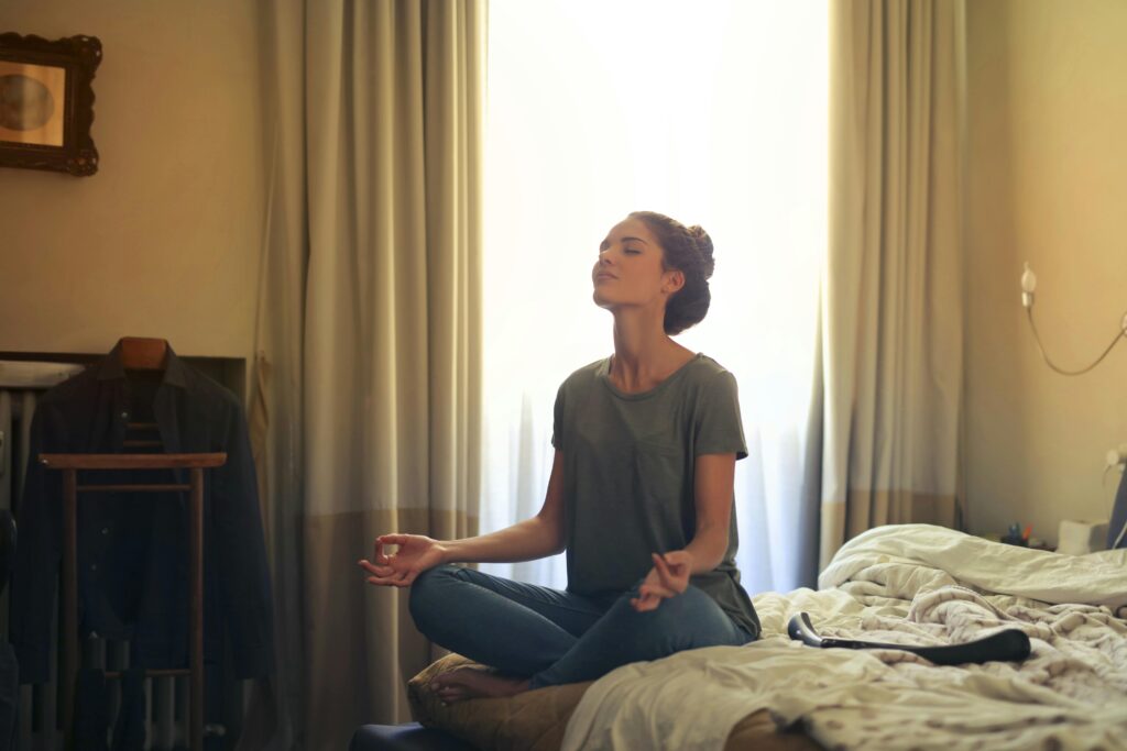 A girl sitting in bed for healing and mediation